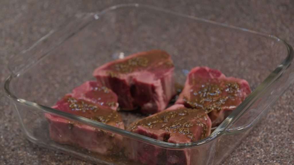 Image of lamb chops marinating in a container